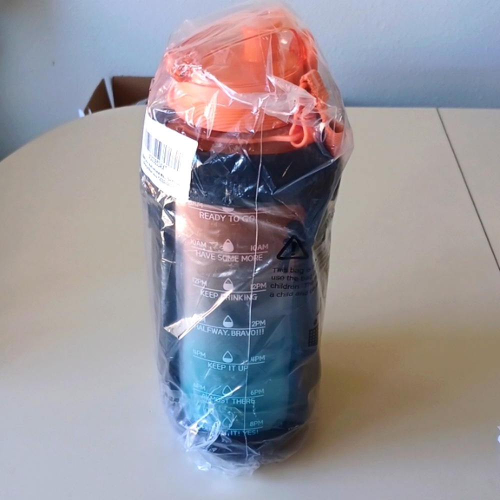 New 64 oz Water Bottle with Phone Case Sleeve